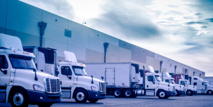 semi trucks unloading at a warehouse