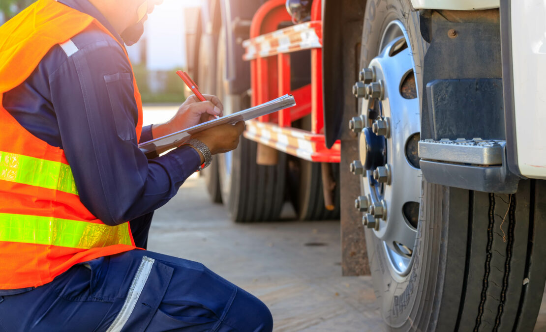 Experienced otr truck driver taking notes on truck performance