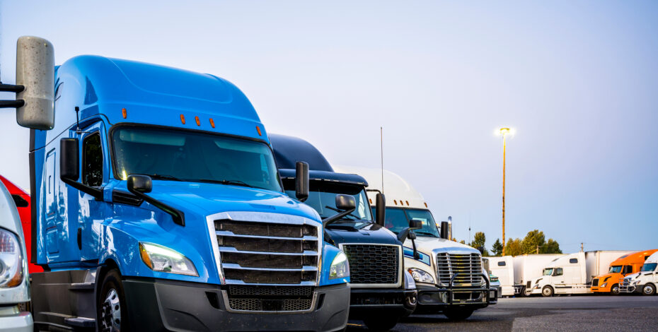 Several trucks are in a parking lot